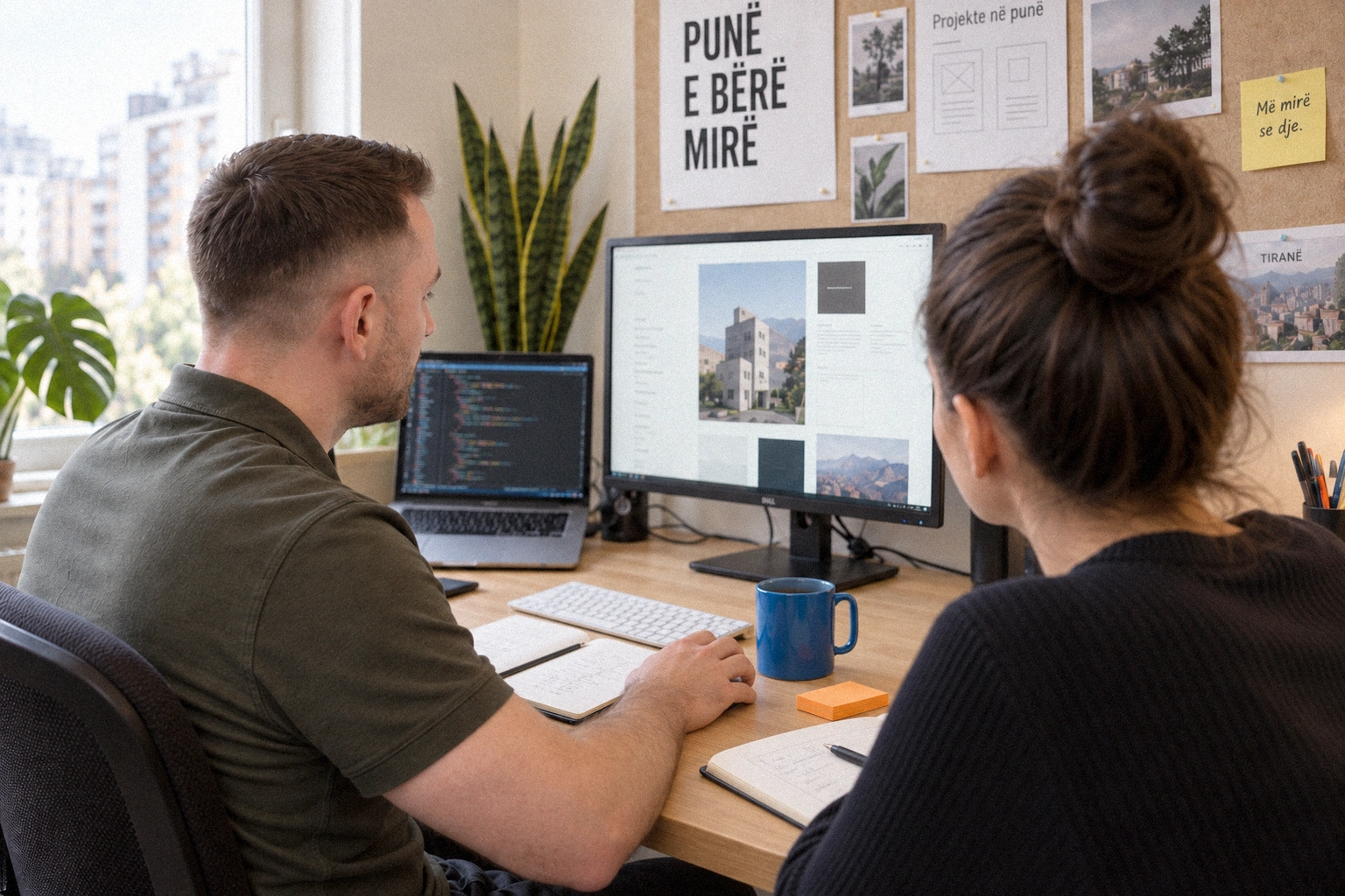 Sajmir and a collaborator reviewing a website together in the studio.